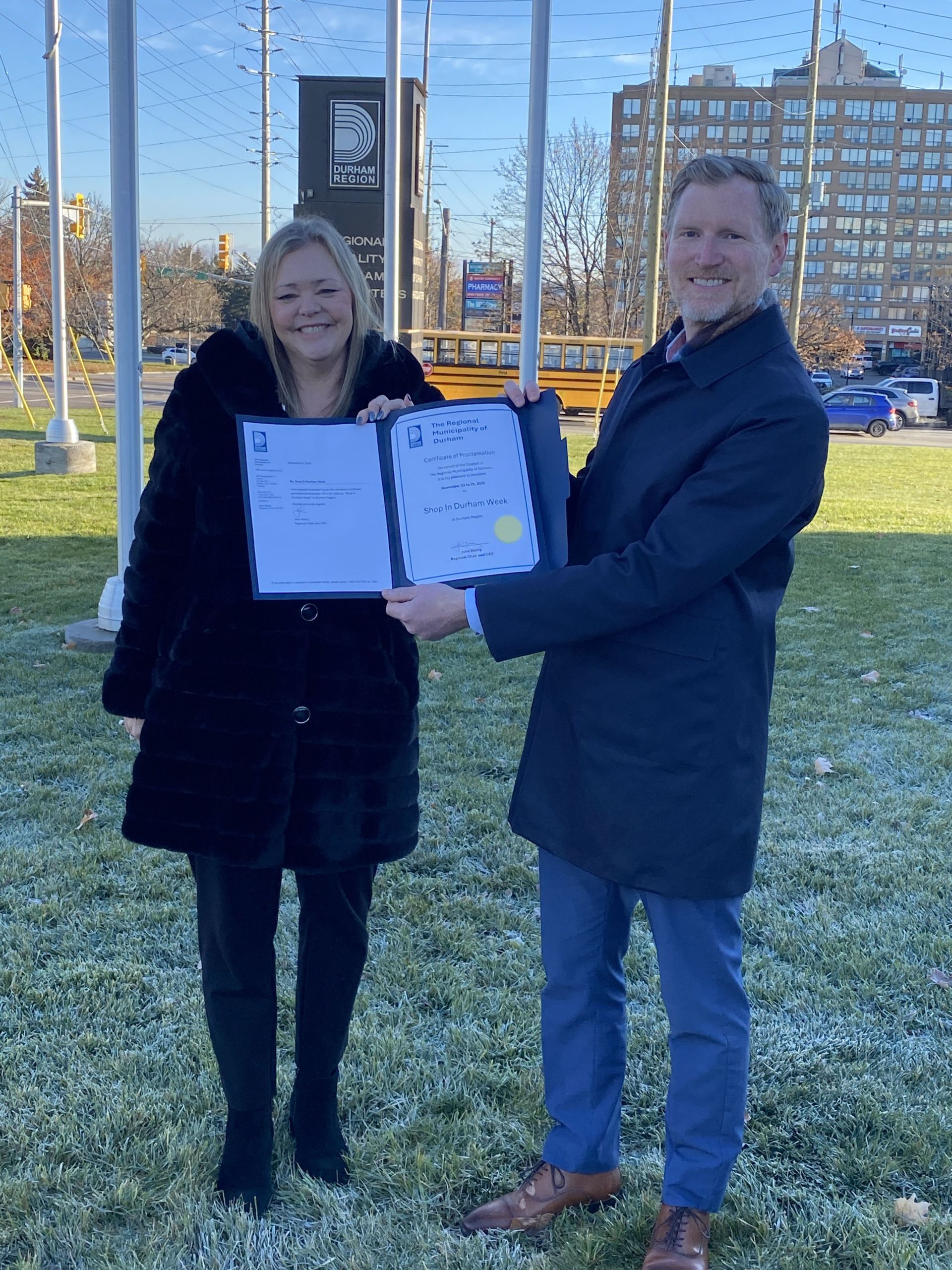 Regional Counillor Rhonda Mulcahy presenting Simon Gill, Director, Invest Durham & Durham Tourism, with a Shop in Durham Week proclamation certificate.