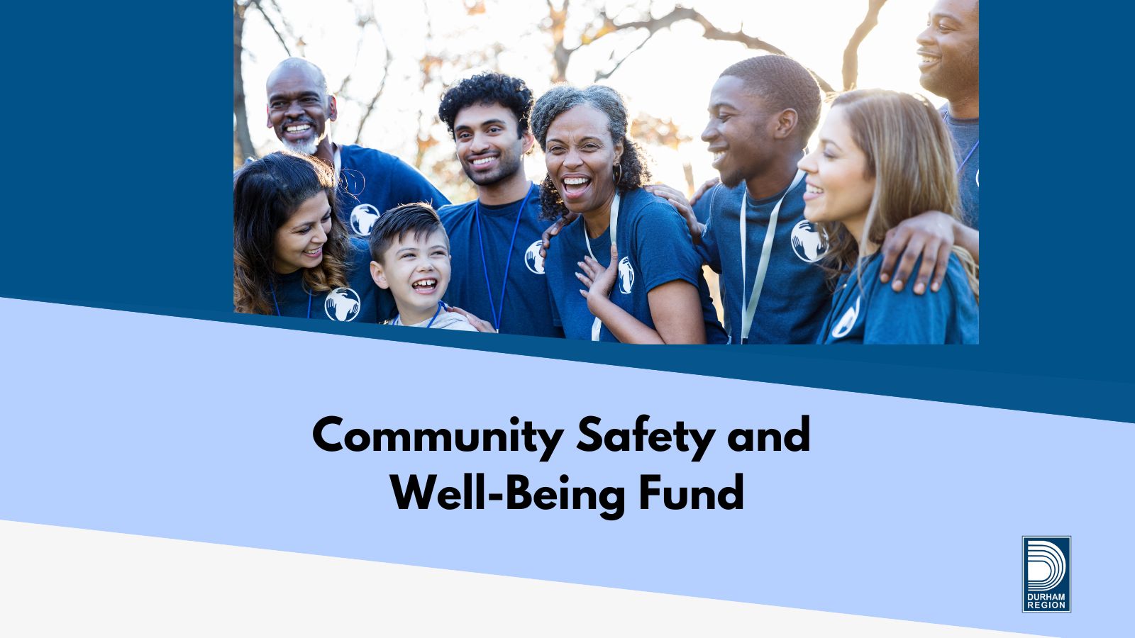 People of all ages smiling and wearing blue shirts