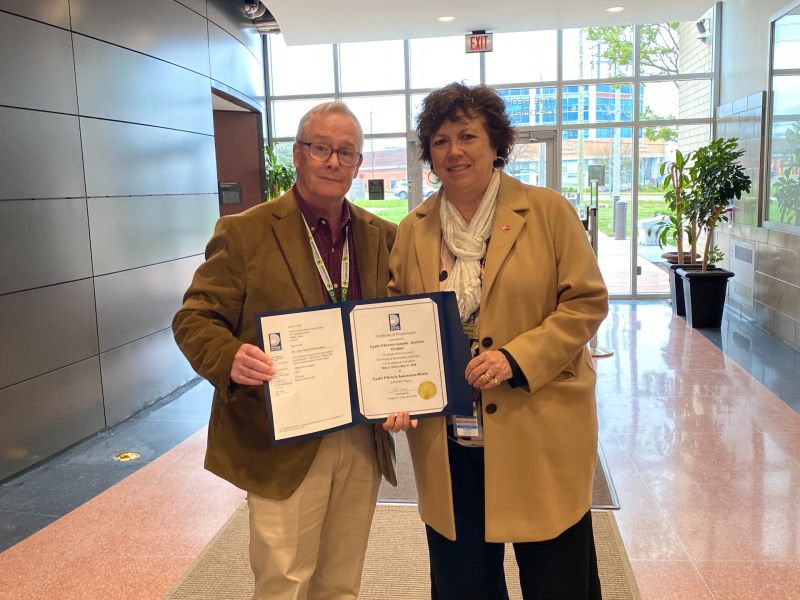 Chair Henry presenting Cystic Fibrosis Canada - Durham Region with an official proclamation for Cystic Fibrosis Awareness Month.