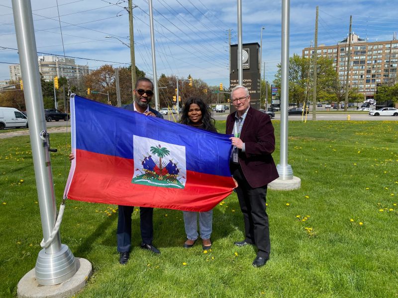 People holding the Haitian Flag. 